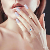 5x3 MM Oval Shape Blue Topaz and 1/20 Ctw Single Cut Diamond Halo Semi-Precious Ring in 10K White Gold