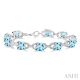 7x7 mm Cushion Cut Blue Topaz and 1/20 Ctw Round Cut Diamond Fashion Bracelet in Sterling Silver